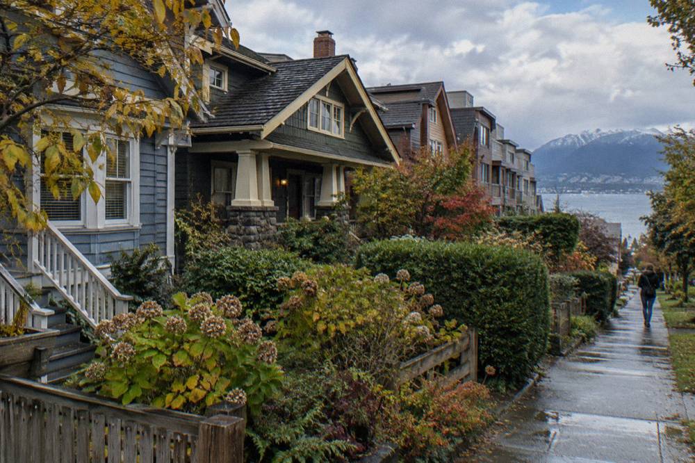 Older wooden houses and townhomes in Kitsilano with the North Shore mountains behind