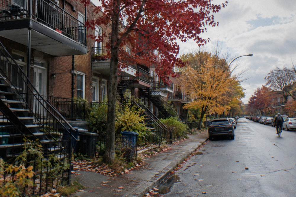 Brick plexes with balconies and outdoor stairs on a Rosemont street in Montreal in autumn