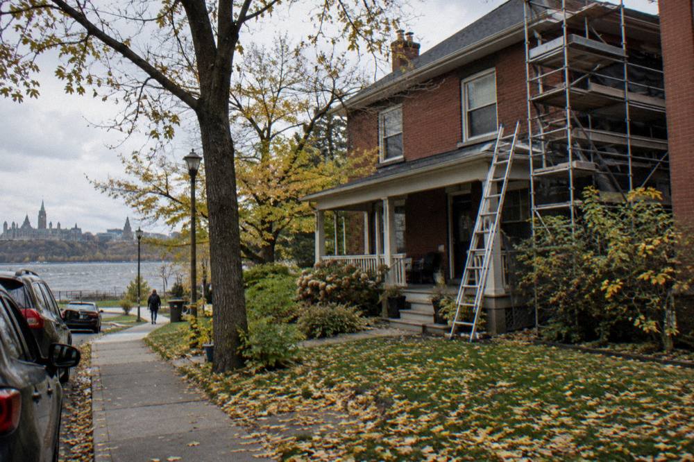 A brick house in Ottawa's Glebe with scaffolding up for a renovation